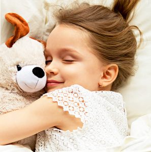 a little girl holding a teddy bear